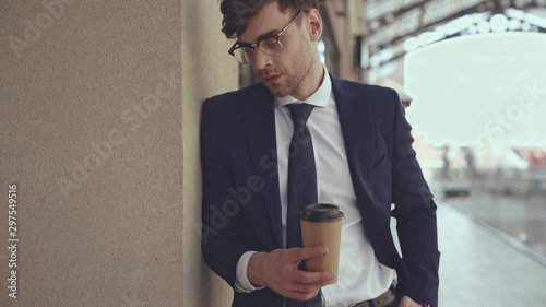 handsome businessman holding paper cup  photo