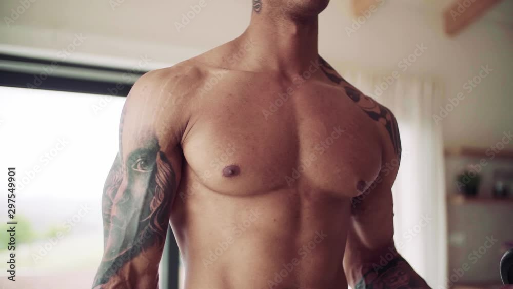 Midsection of young man doing exercise indoors at home, a body workout.