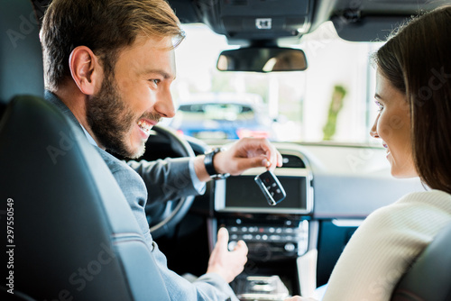 selective focus of happy man and woman looking at each other in car © LIGHTFIELD STUDIOS