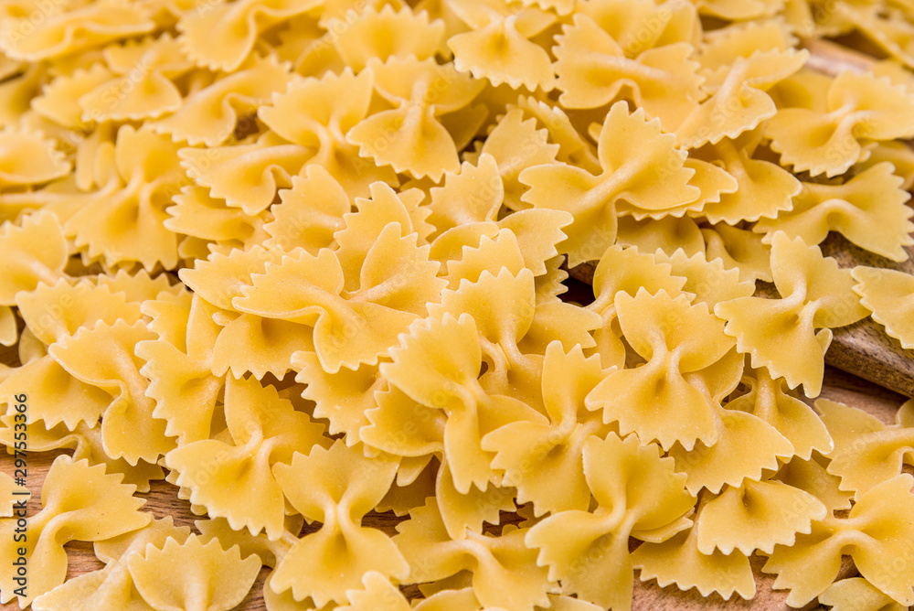 some farfalle pasta forming a background pattern some farfalle pasta forming a background pattern
