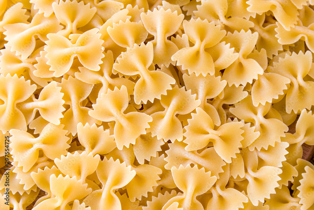 some farfalle pasta forming a background pattern some farfalle pasta forming a background pattern