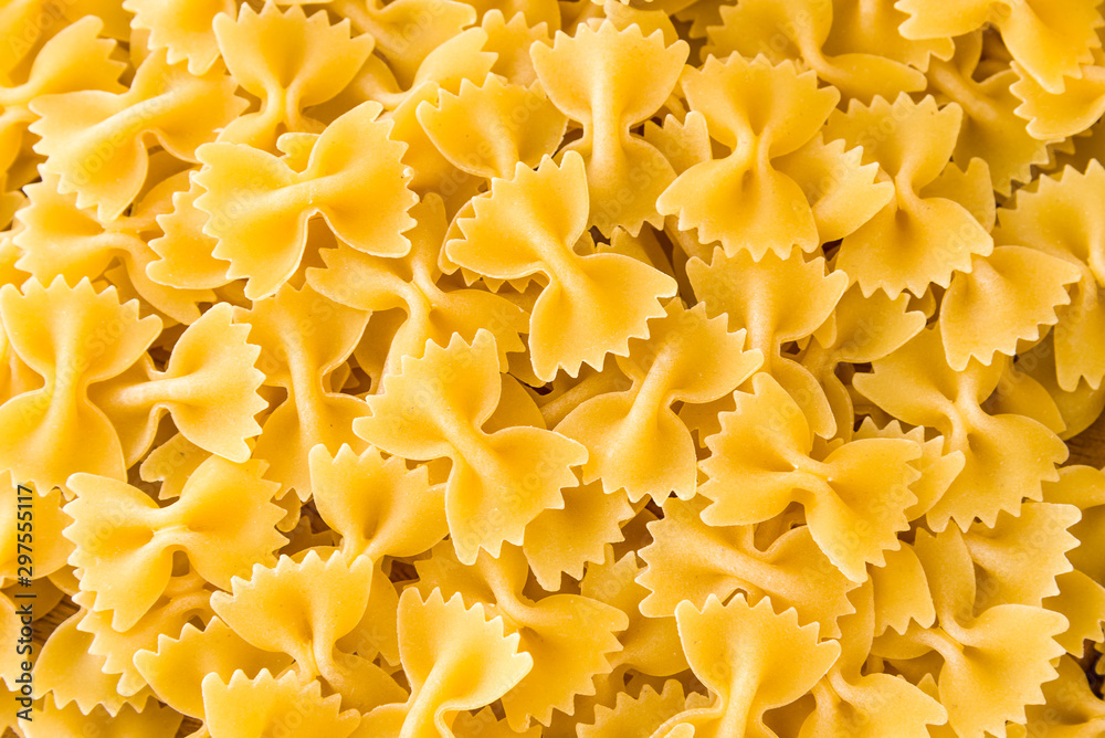 some farfalle pasta forming a background pattern some farfalle pasta forming a background pattern