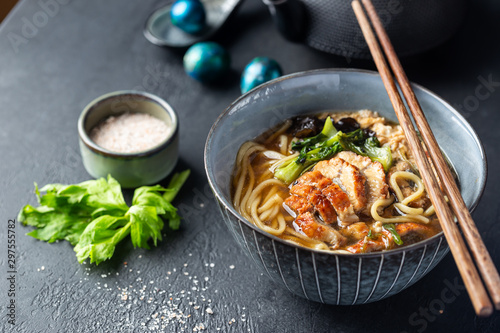 japanese soup with fried eel Yanagawa Nabe in a bowl on dark background photo