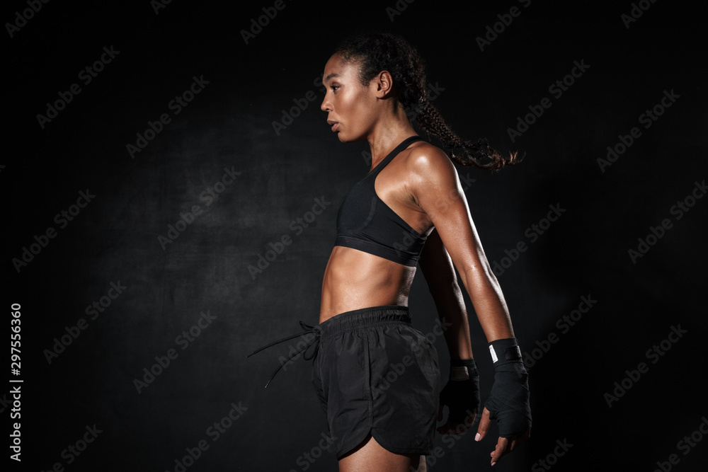 Image of pretty african american woman standing in boxing hand wraps