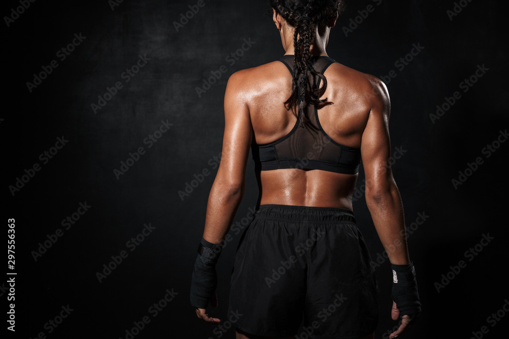 Image of young african american woman standing in boxing hand wraps