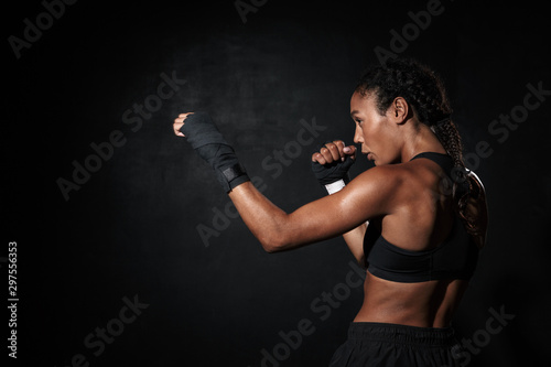 Image of healthy african american woman boxing in hand wraps