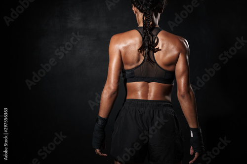 Fototapeta Naklejka Na Ścianę i Meble -  Image of young african american woman standing in boxing hand wraps