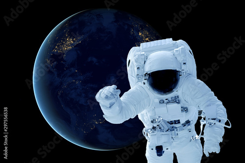 Fototapeta Naklejka Na Ścianę i Meble -  Astronaut above the planet Earth. Elements of this image were furnished by NASA.