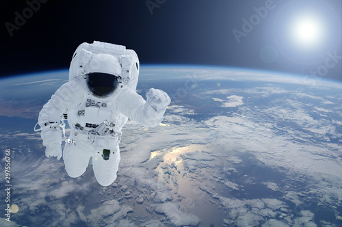 Astronaut above the planet Earth. Elements of this image were furnished by NASA. photo