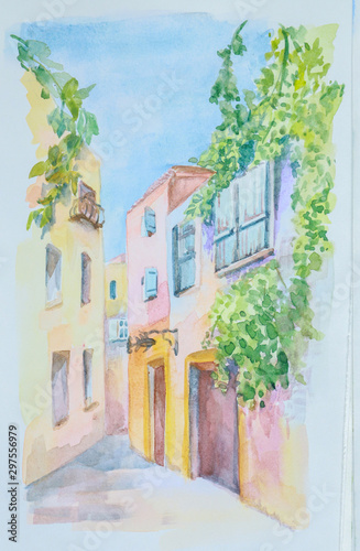 On a white paper, a cityscape of the streets of the European old city is executed by hand in watercolor.