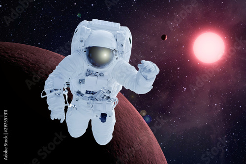 Fototapeta Naklejka Na Ścianę i Meble -  Astronaut in orbit of the red planet. Elements of this image were furnished by NASA.