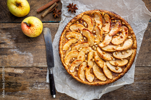 Homemade delicious fresh baked rustic apple pie on dark background, top view photo