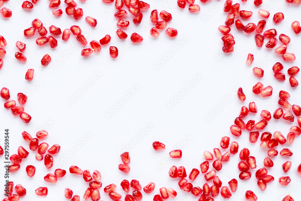 Frame made of pomegranate seeds isolated on white background.