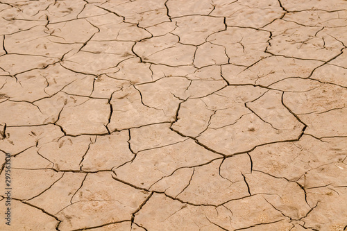 Dry cracked earth as a background close-up. Environmental disaster. Drought.