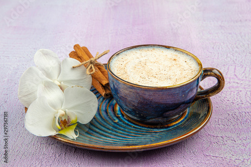 Turkish Salep or Sahlep with cinnamon sticks / Christmas Eggnog. Served with cinnamon sticks and orchid flower. photo