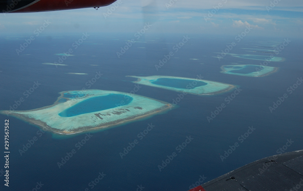 Obraz premium Weird forms of Maldivian atolls as seen from the local plane