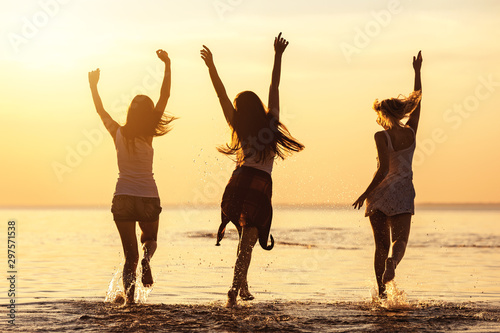 Three happy girls at caml sea beach and sunset
