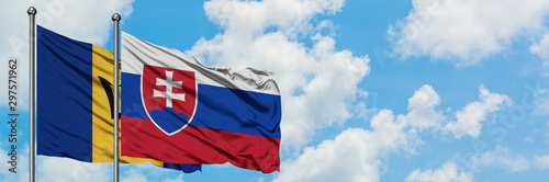 Photography Barbados and Slovakia flag waving in the wind against white cloudy blue sky together
