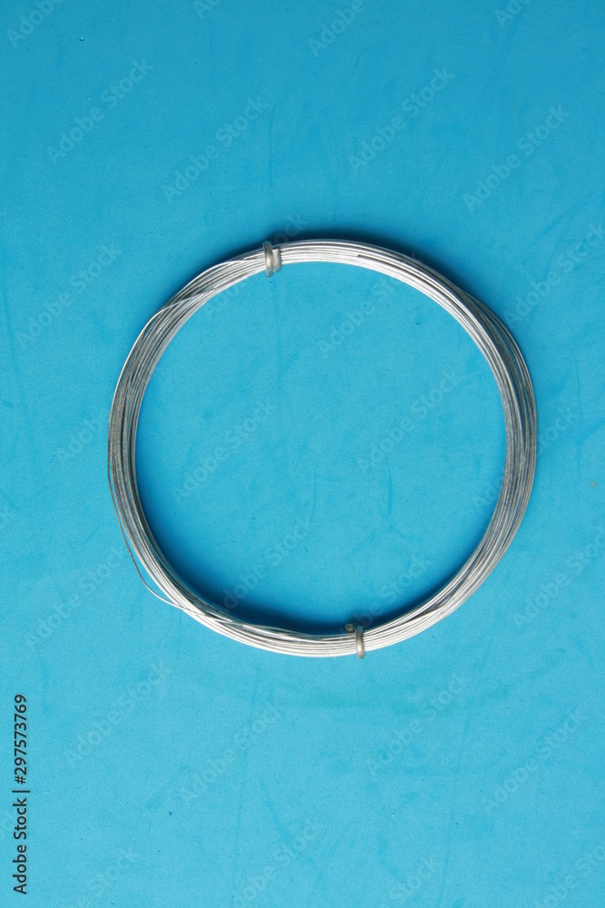 roll of metal wire of hardware store on colored background roll of metal wire of hardware store on colored background