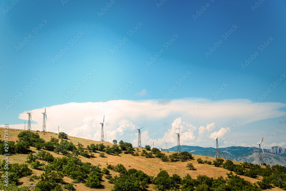 Wind power plant against the blue sky