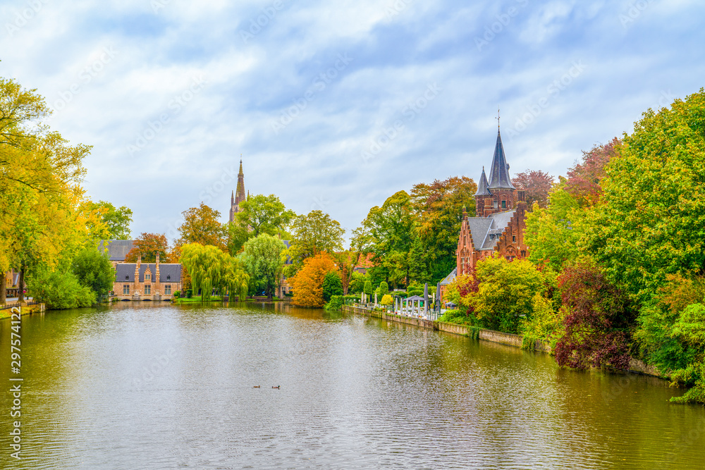 Minnewater castle at the Lake of Love during fall, Bruges, Belgium