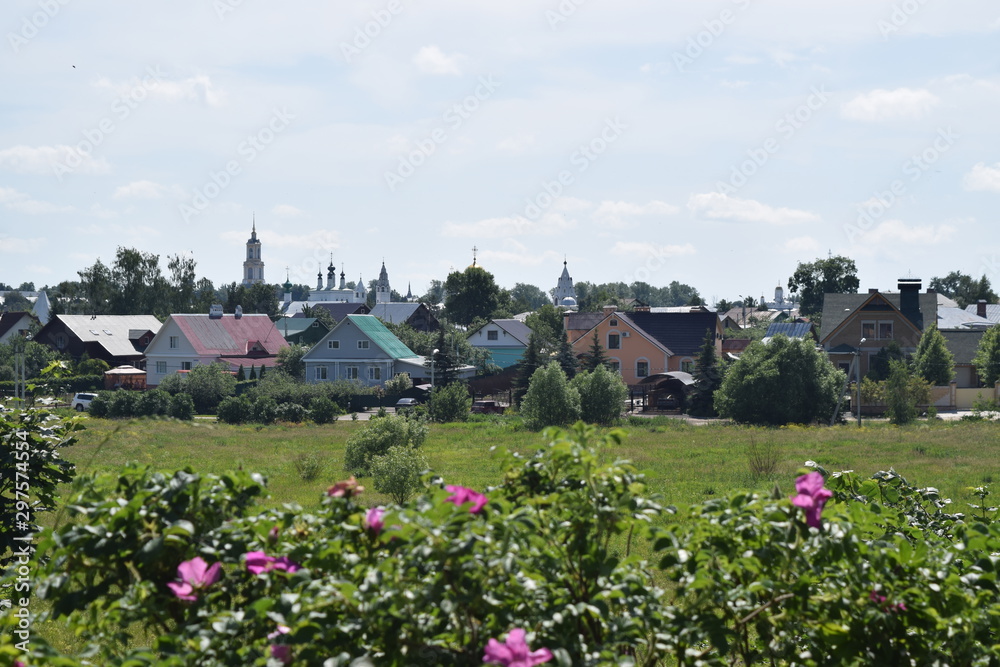 View of a provincial Russian town on a Sunny day with churches in the background. Suzdal, Russia.