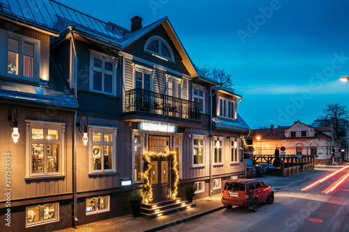 Parnu, Estonia. Night View Of Puhavaimu Street With Old Buildings, Houses, Restaurants, Cafe, Hotels And Shops In Evening Night Illuminations