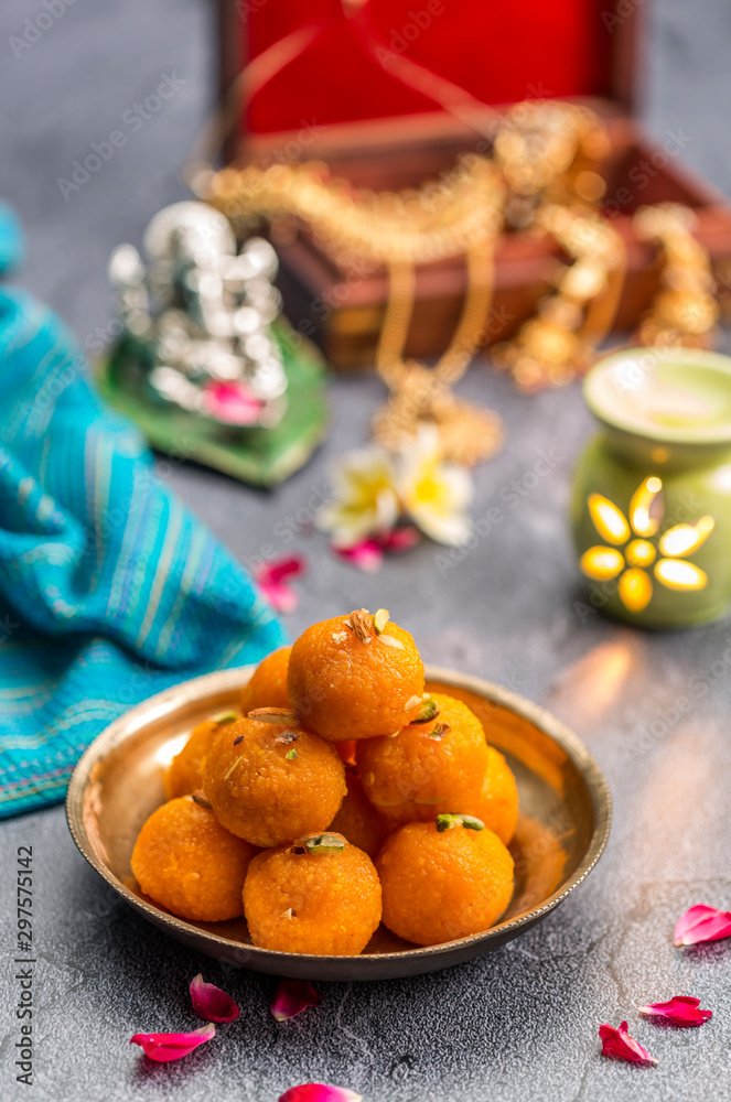 Fototapeta premium Motichoor Ladoo or Laddu - made from fine bundi, ball shaped sweets popular in indian subcontinent cooked with sugar, ghee or oil
