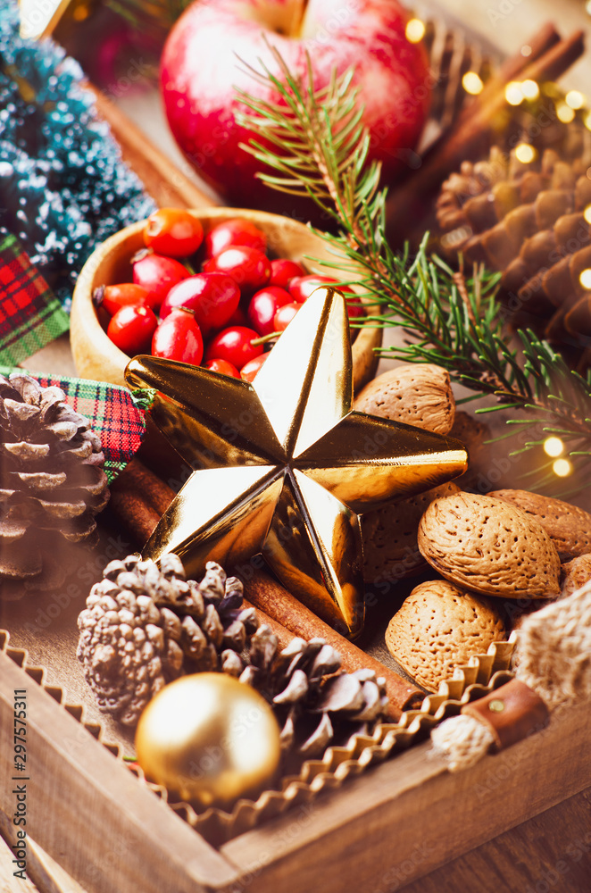 Variety of Christmas and New year decorations  in wood tray over rustic background.  Flat lay, space.