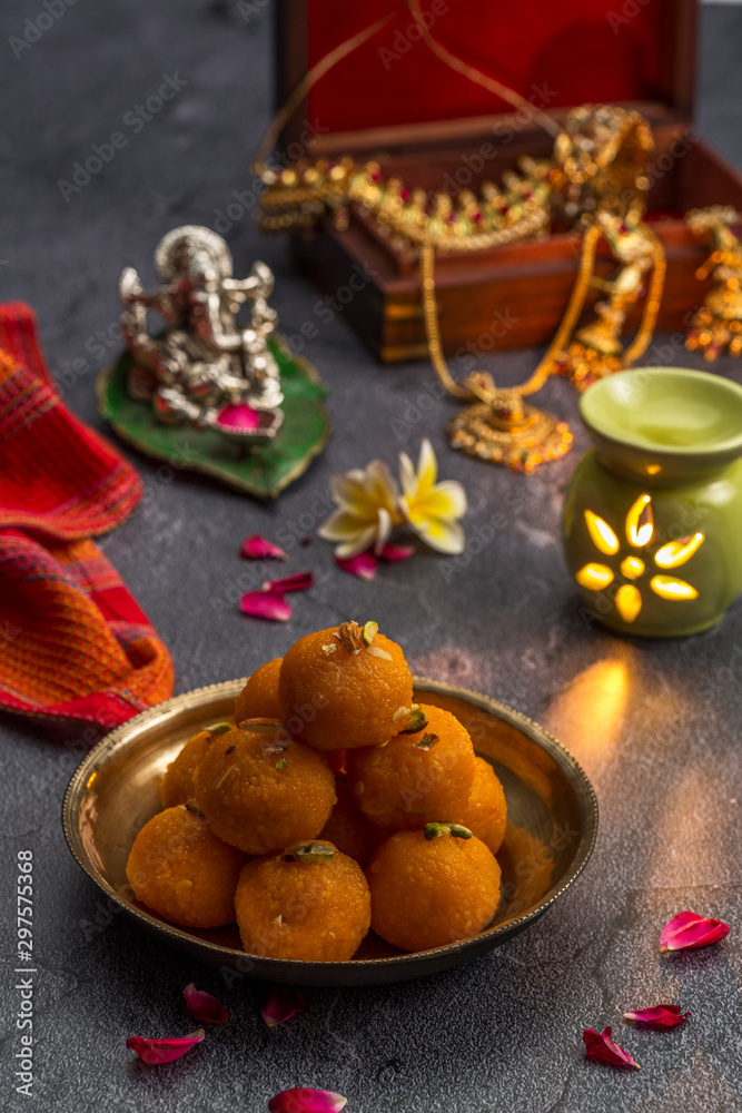 Fototapeta premium Motichoor Ladoo or Laddu - made from fine bundi, ball shaped sweets popular in indian subcontinent cooked with sugar, ghee or oil