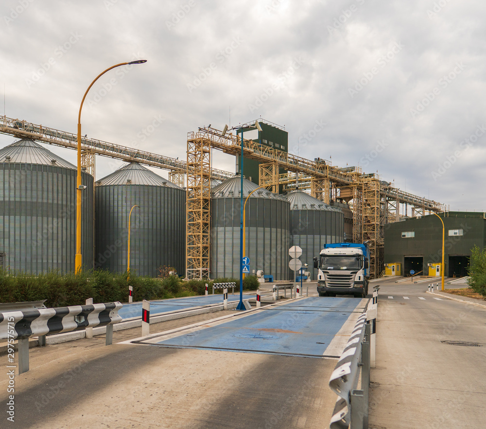 Modern elevator for storing grain against the sky. Grain drying complex, storage and transportation of grain. Large granary in the field. Agricultural industry Modern elevator for storing grain against the sky. Grain drying complex, storage and transportation of grain. Large granary in the field. Agricultural industry