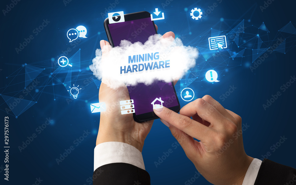 Female hand holding smartphone with MINING HARDWARE inscription, cloud technology concept Female hand holding smartphone with MINING HARDWARE inscription, cloud technology concept