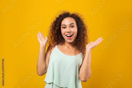 Portrait of happy African-American woman on color background
