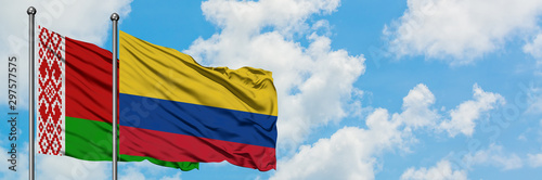 Belarus and Colombia flag waving in the wind against white cloudy blue sky together. Diplomacy concept, international relations.