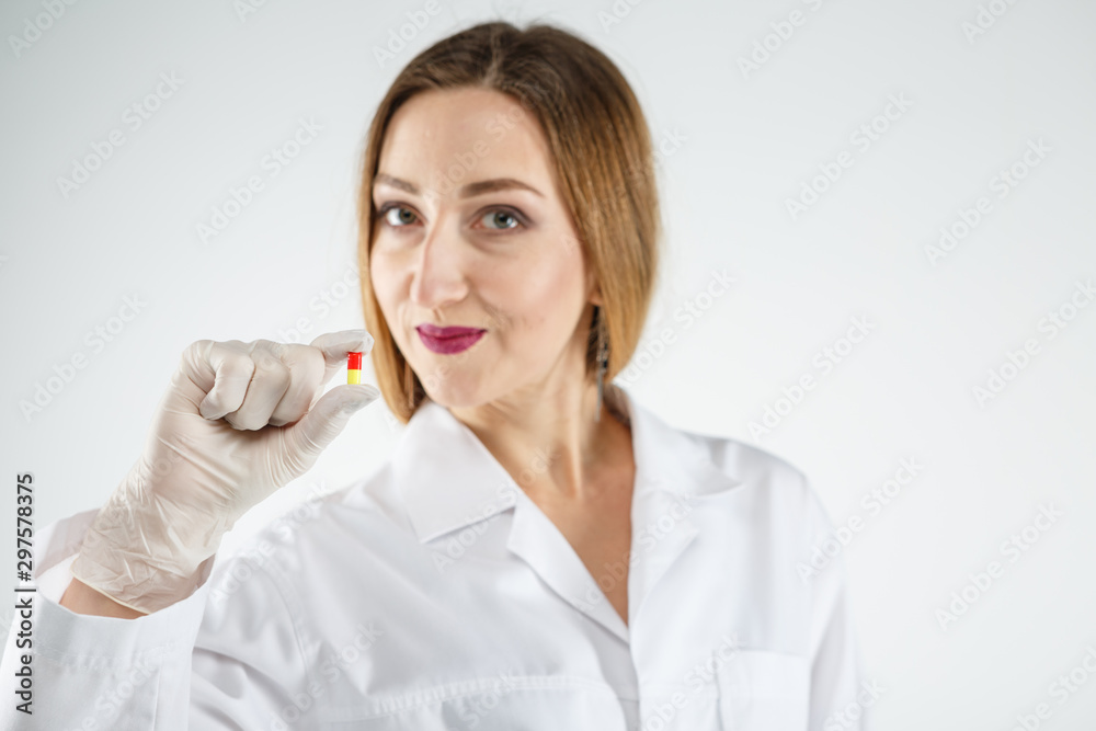 a doctor with a pill on a white background. a doctor with a pill on a white background.