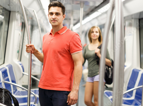 Man with his girlfriend are standing in the train