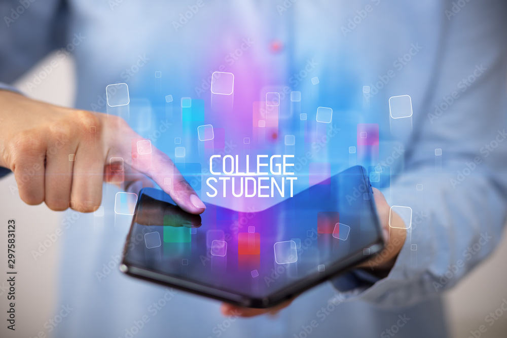 Young man holding a foldable smartphone with COLLEGE STUDENT inscription, educational concept Young man holding a foldable smartphone with COLLEGE STUDENT inscription, educational concept
