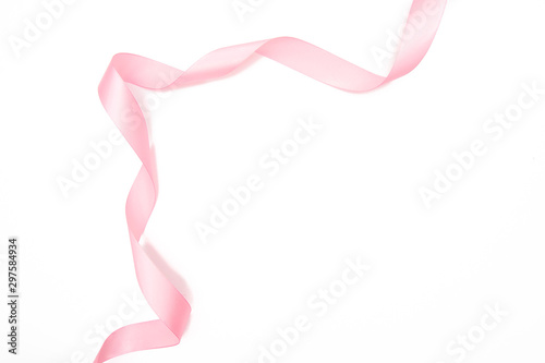 Obraz na plátně Curled pink ribbon with highlights isolated on white background, top view