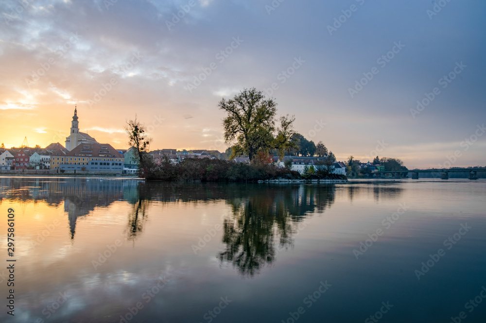 Fototapeta premium autumn tree in the river inn