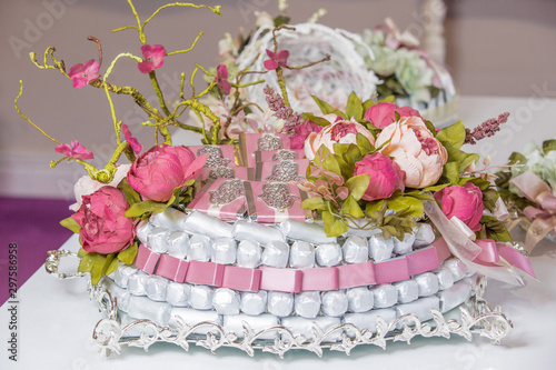 chocolate khoncha in pink and white, decorated with artificial flowers photo