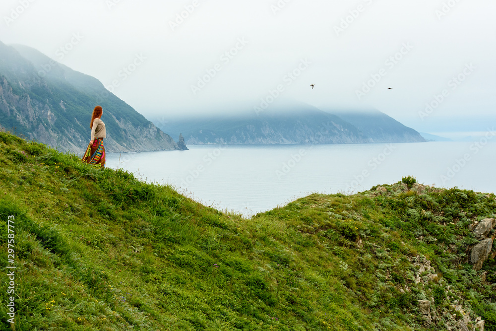 Long-haired girl on sea shore