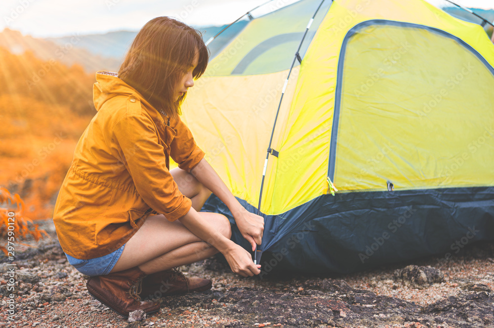 People pitching a tent on the ground near the mountain. Relaxing holiday  travel long holiday concept. Photos | Adobe Stock