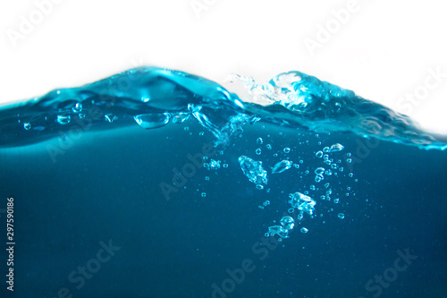 close-up shot of blue water surface and shining blue bubbles underwater with white background
