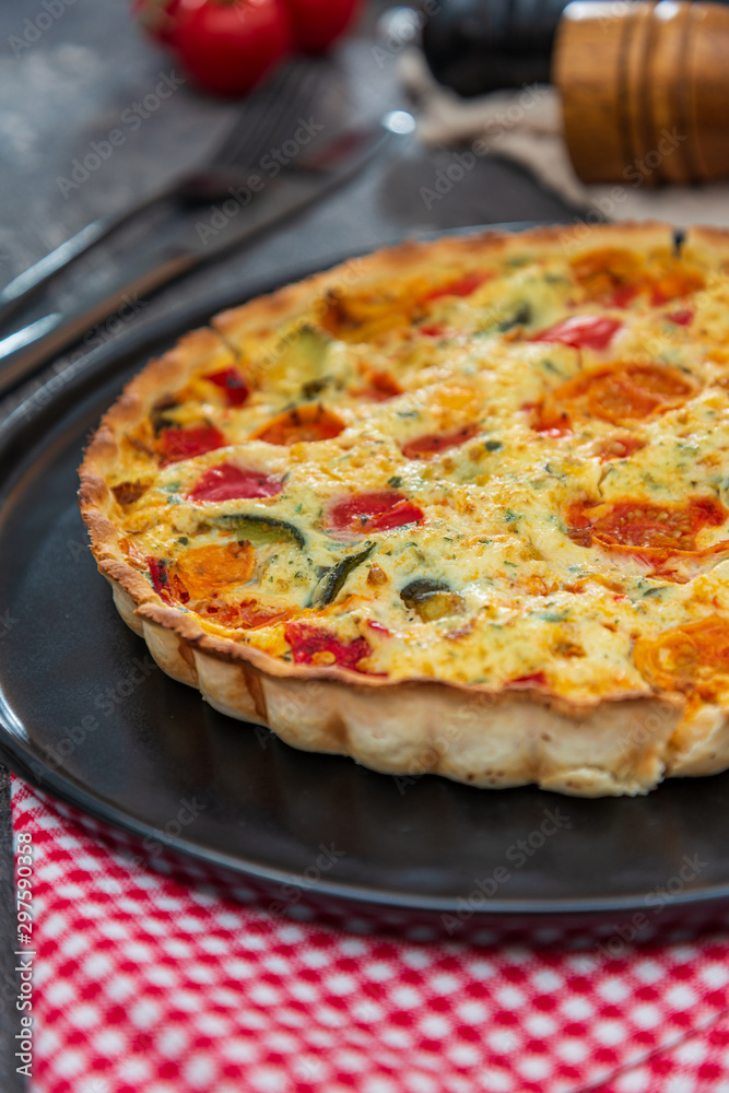 vegetable pie with cherry tomatoes, grilled peppers and courgettes with fresh eggs and fresh cream