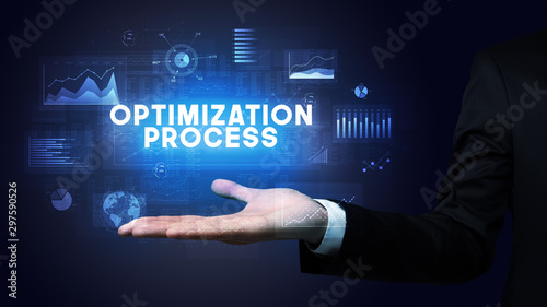 Hand of Businessman holding OPTIMIZATION PROCESS inscription, business success concept