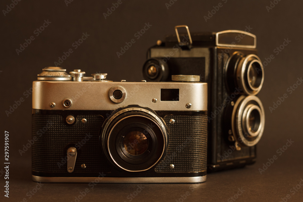Lutsk, Ukraine - July 7th, 2019: Two old vintage film cameras on a dark background