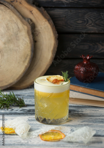 pineapple rum garnished with ice, dried orange, rosmarine photo