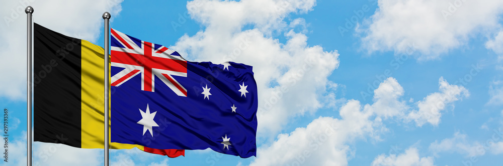 Belgium and Australia flag waving in the wind against white cloudy blue sky together. Diplomacy concept, international relations. Belgium and Australia flag waving in the wind against white cloudy blue sky together. Diplomacy concept, international relations.