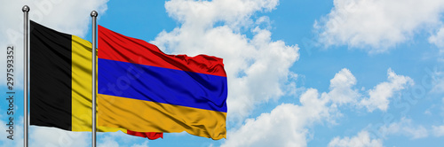 Belgium and Armenia flag waving in the wind against white cloudy blue sky together. Diplomacy concept, international relations.