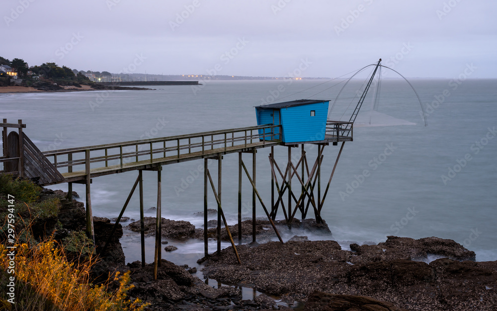 Typical blue carrelet fishing hut in Pornic during the blue hour, Loire-Atlantique department, western France. Typical blue carrelet fishing hut in Pornic during the blue hour, Loire-Atlantique department, western France.